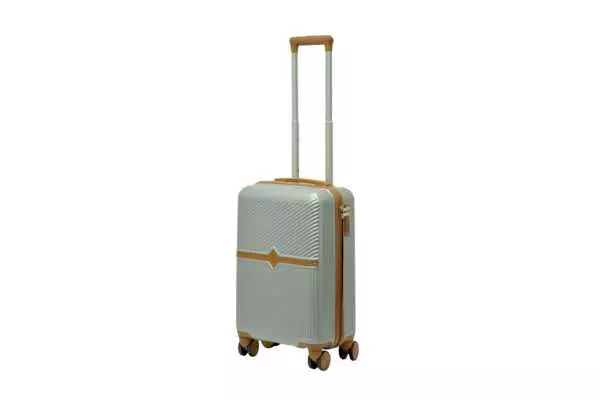 20 inch silver hard shell luggage with a tan accent band and top handle, side view with four wheels