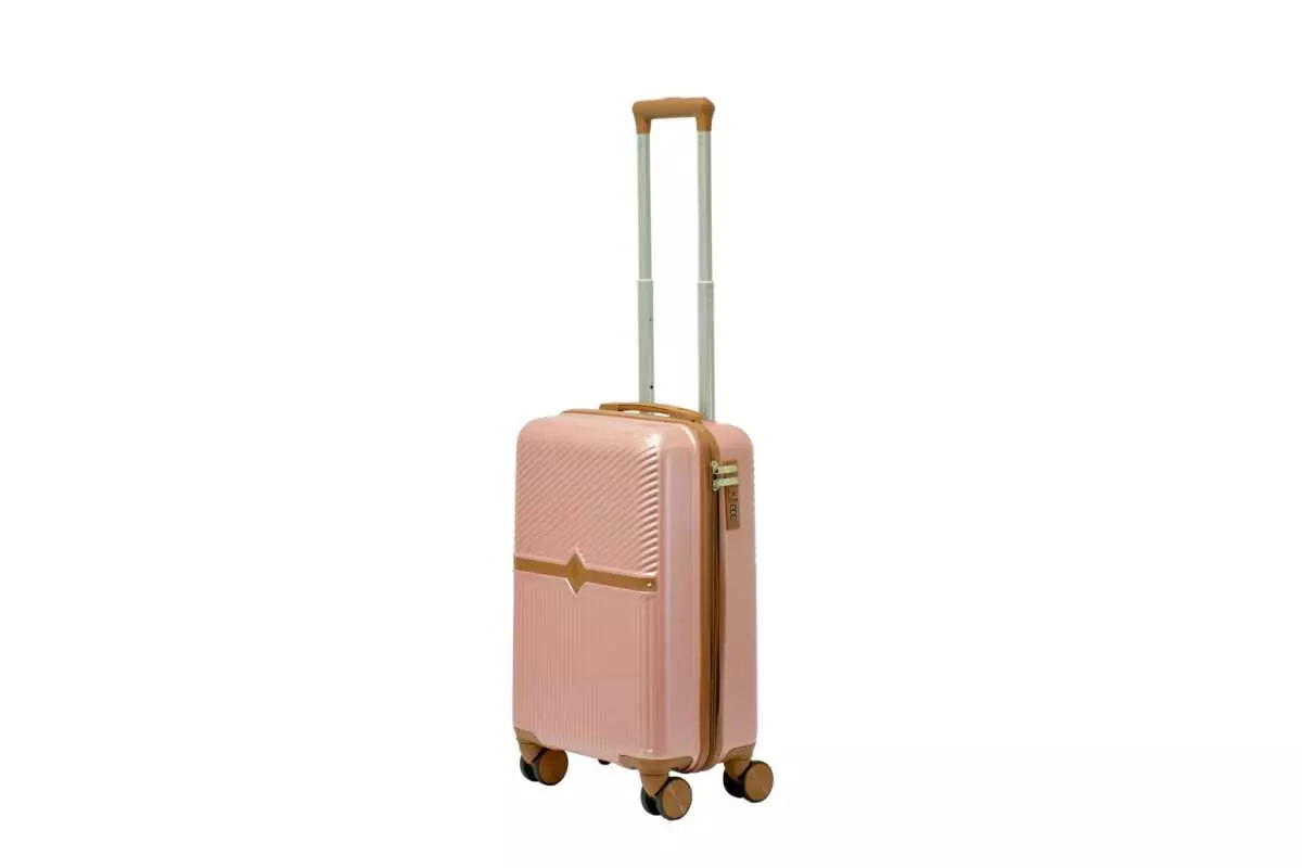 20 inch rose gold hard shell luggage with a tan accent band and top handle, side view with four wheels