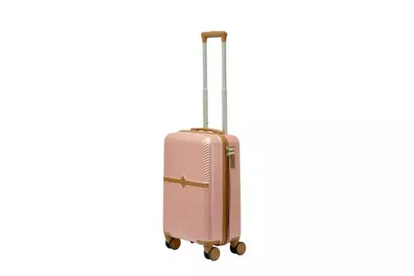 20 inch rose gold hard shell luggage with a tan accent band and top handle, side view with four wheels