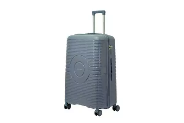 28 inch blue hard shell luggage with a round emblem panel, side view with four wheels