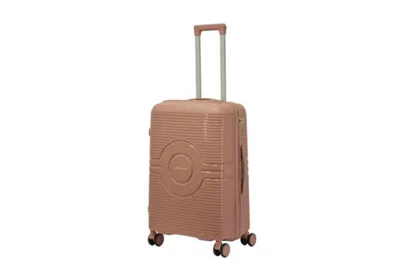 24 inch rose gold hard shell luggage with a round emblem panel, side view with four wheels