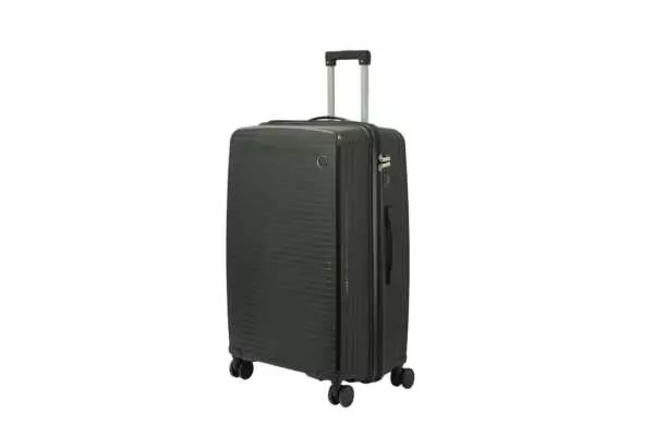 28 inch black hard shell luggage with fine horizontal ribs and a small round badge, side view with four wheels