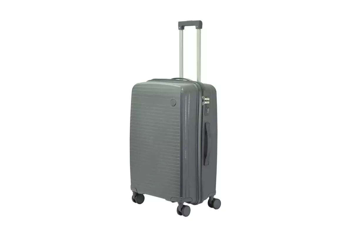 24 inch dark grey hard shell luggage with fine horizontal ribs and a small round badge, side view with four wheels