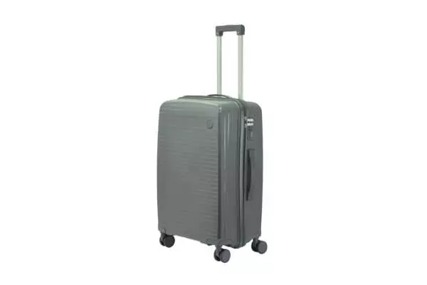 24 inch dark grey hard shell luggage with fine horizontal ribs and a small round badge, side view with four wheels